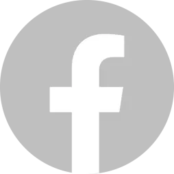 A digital icon featuring the Facebook logo, represented by a white lowercase "f" centered inside a gray circular background. The design is minimalistic and typically used for social media links or branding purposes.